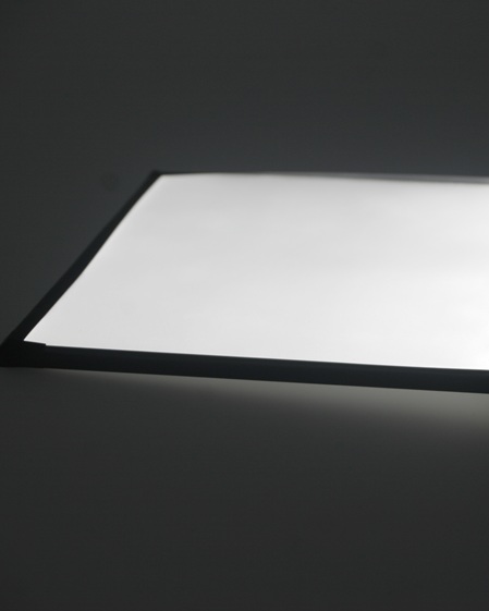 Board with light reflective foil on dark background