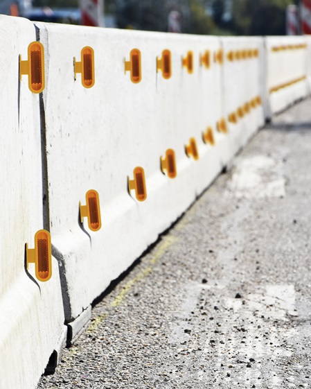 Orange road reflectors on a protective wall